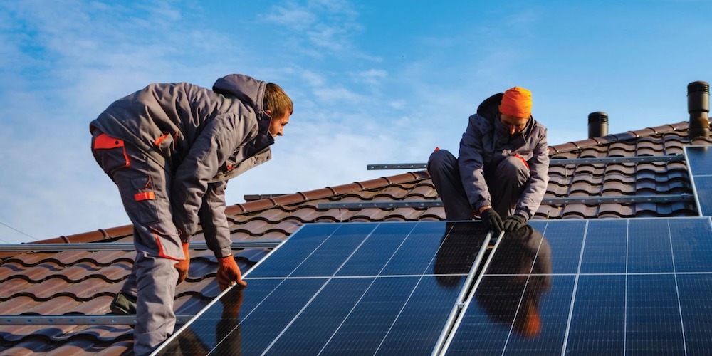 solar installers working on a roof